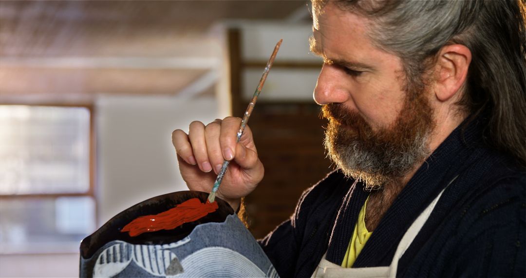 Artist Painting Ceramic Pot in Studio with Brush - Free Images, Stock Photos and Pictures on Pikwizard.com