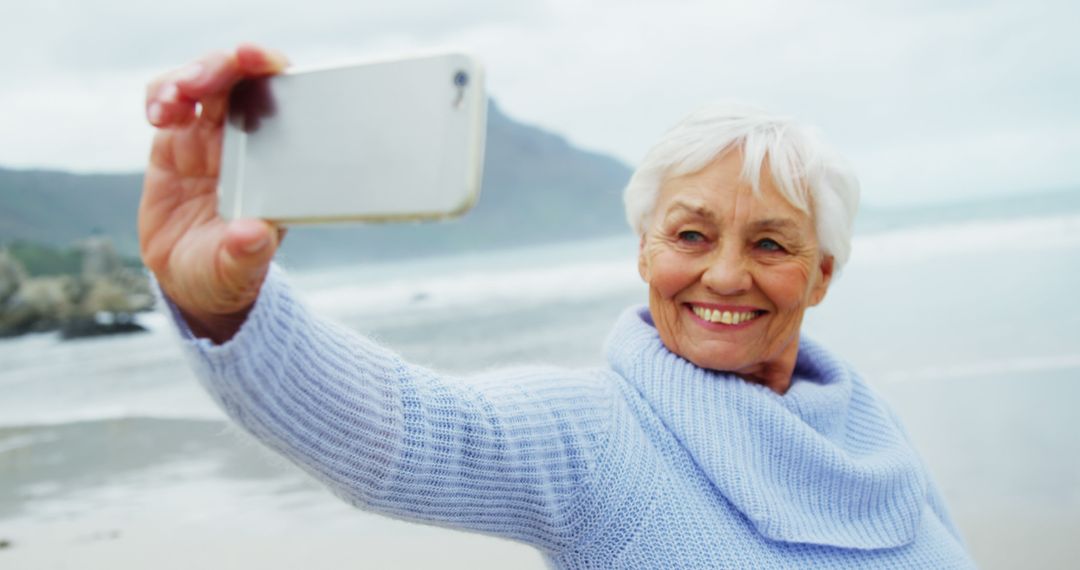 Senior Woman Taking Selfie on Beach - Free Images, Stock Photos and Pictures on Pikwizard.com