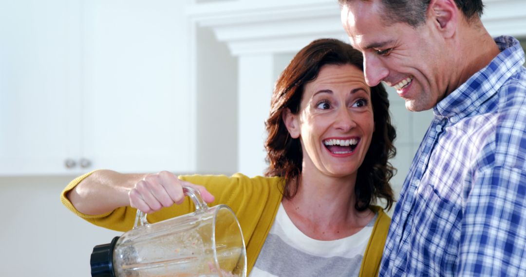 Joyful Middle-Aged Couple Cooking Together in Kitchen