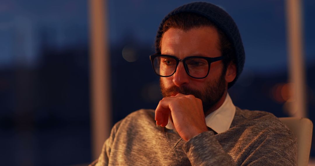 Man Deep in Thought at Dusk with Glasses and Beanie - Free Images, Stock Photos and Pictures on Pikwizard.com