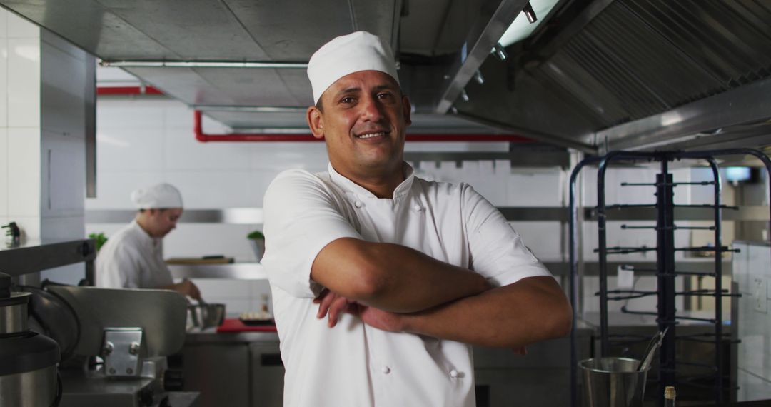 Confident Chef Standing with Arms Crossed in Professional Kitchen - Free Images, Stock Photos and Pictures on Pikwizard.com