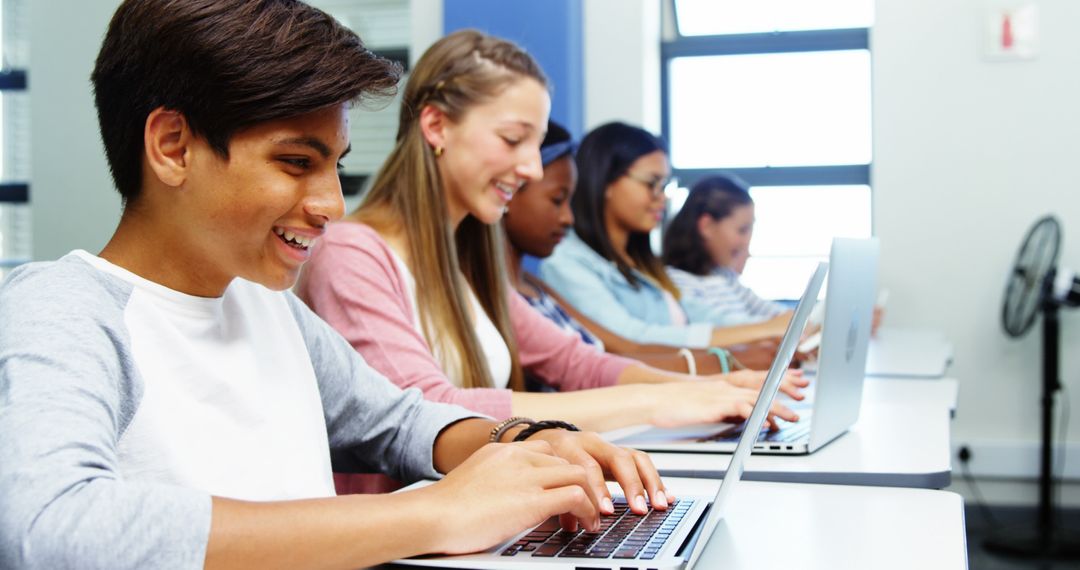 Group of Diverse Students Typing on Laptops in Classroom - Free Images, Stock Photos and Pictures on Pikwizard.com