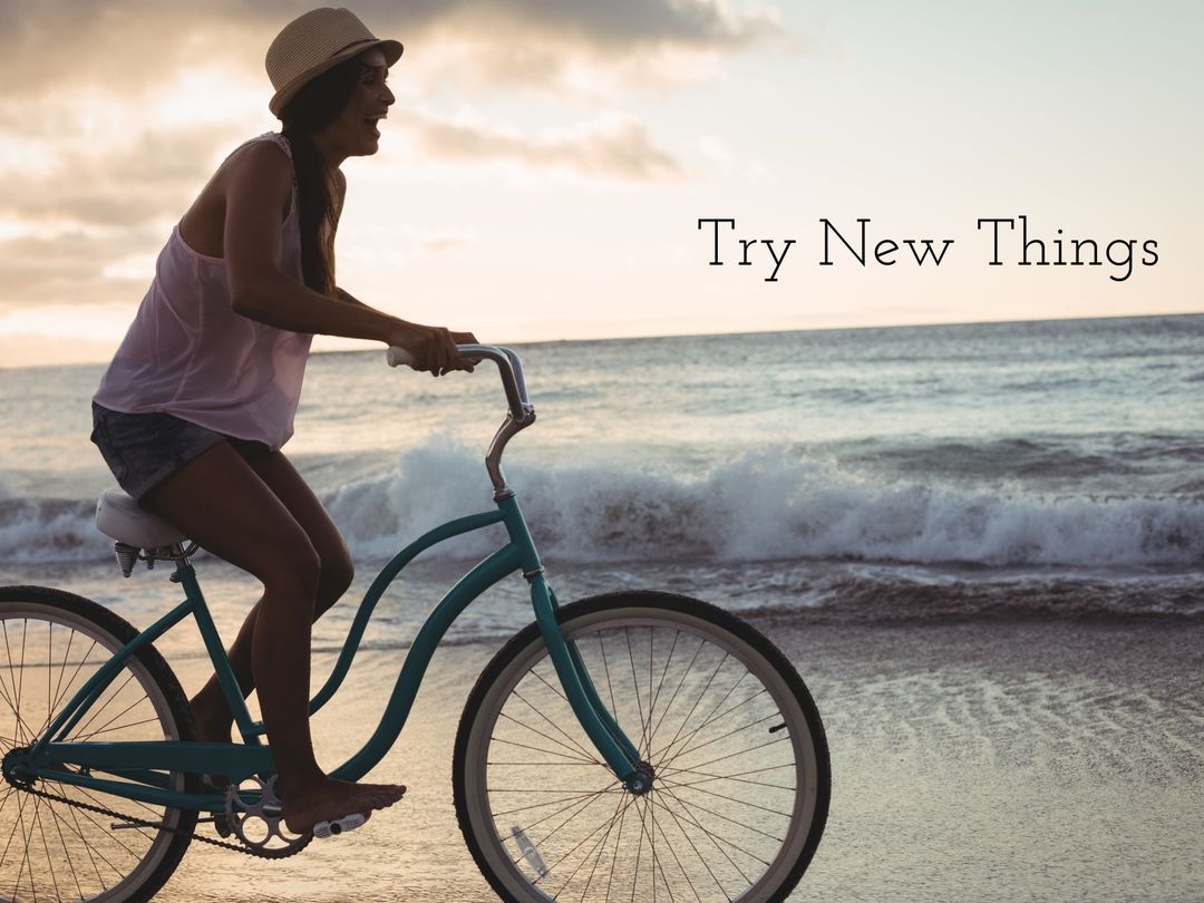 Woman Cycling on Beach at Sunset with Positive Message