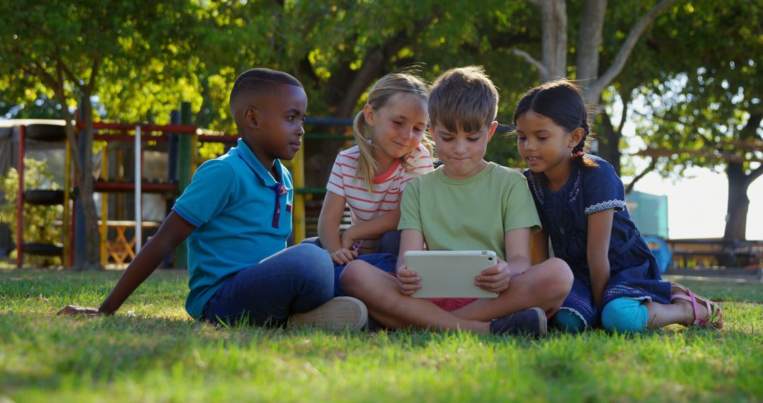 Diverse group of kids using tablet outdoors in park - Free Images, Stock Photos and Pictures on Pikwizard.com