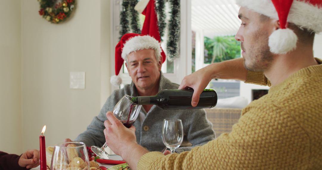 Family Celebrating Christmas Dinner with Wine - Free Images, Stock Photos and Pictures on Pikwizard.com