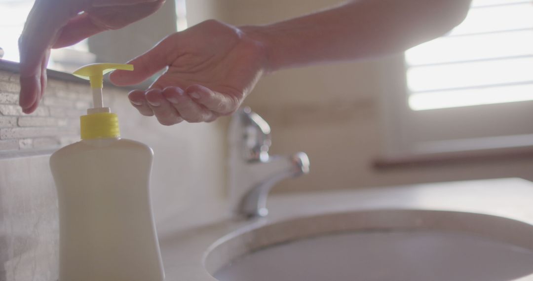 Closeup of Hands Dispensing Liquid Soap in Bathroom - Free Images, Stock Photos and Pictures on Pikwizard.com