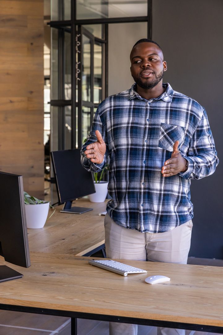 Professional Man Presenting in Modern Office Environment