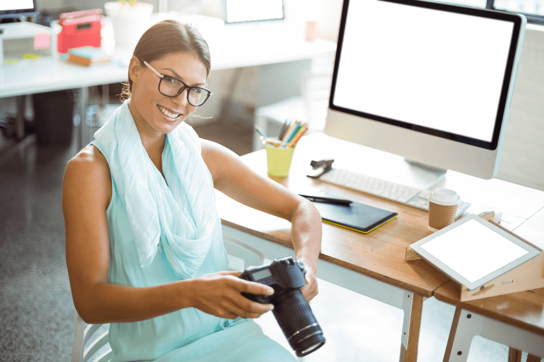 Transparent Smiling Designer Holding Camera with Office Background