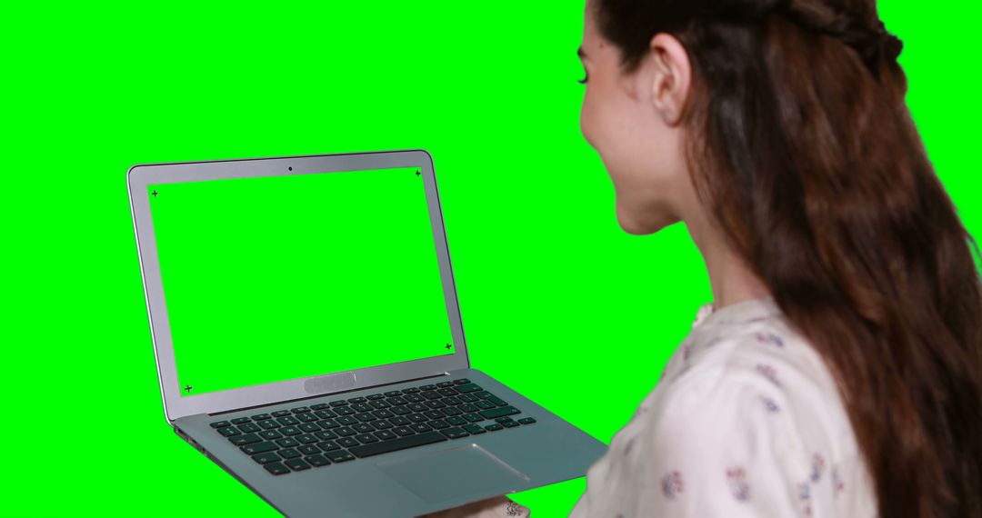 Woman using laptop against green screen - Free Images, Stock Photos and Pictures on Pikwizard.com