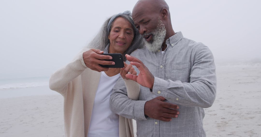 Senior Couple Enjoying Time at Beach Taking Selfie Together - Free Images, Stock Photos and Pictures on Pikwizard.com