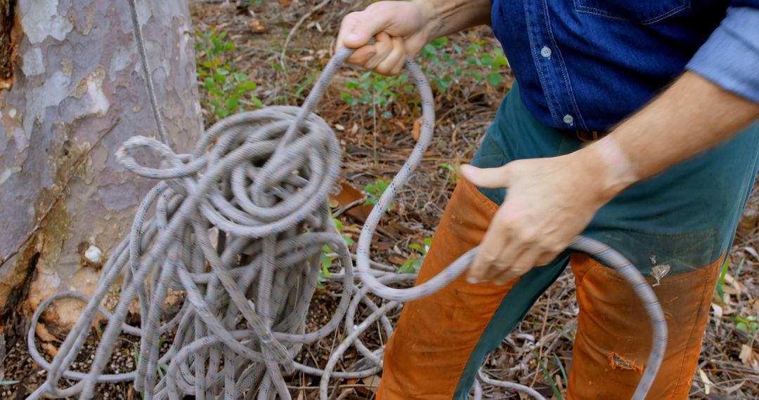 Man Organizing Climbing Rope Outdoors - Free Images, Stock Photos and Pictures on Pikwizard.com