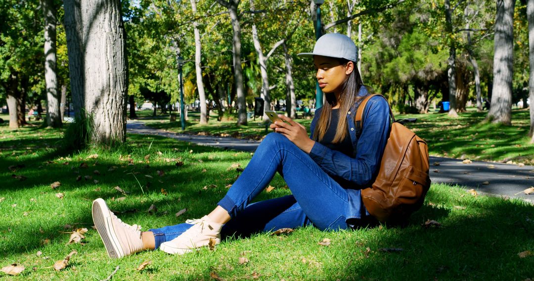 Student Relaxing in Park with Smartphone - Free Images, Stock Photos and Pictures on Pikwizard.com