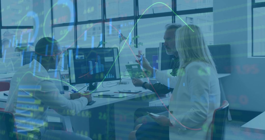 Coworkers Analyzing Data on Computers in Modern Office