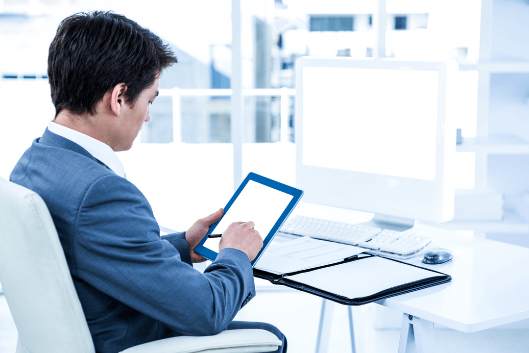 Businessman Utilizing Digital Tablet in Modern Office with Transparent Screen