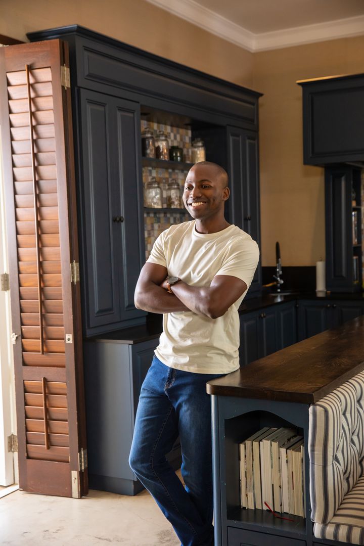 Man Relaxing in Modern Rustic Kitchen with Dark Cabinets