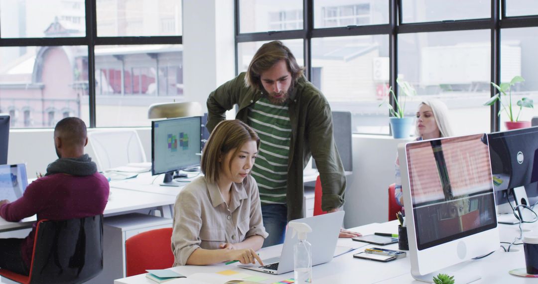 Collaborating Colleagues in Modern Open-Plan Office Workspace
