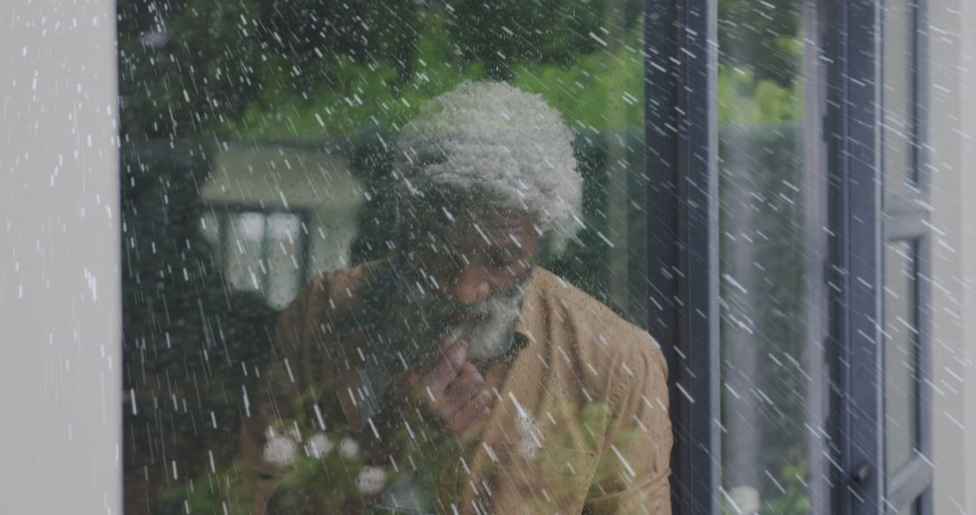 Contemplative Elder Behind Rain-Soaked Window