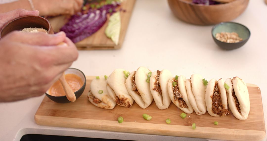 Sprinkling Sesame Seeds on Freshly Made Bao Buns