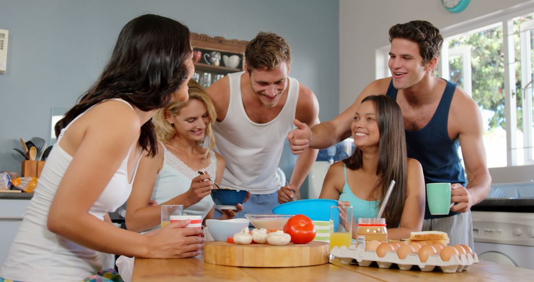 Group of Friends Having Breakfast at Home with Laughter - Free Images, Stock Photos and Pictures on Pikwizard.com