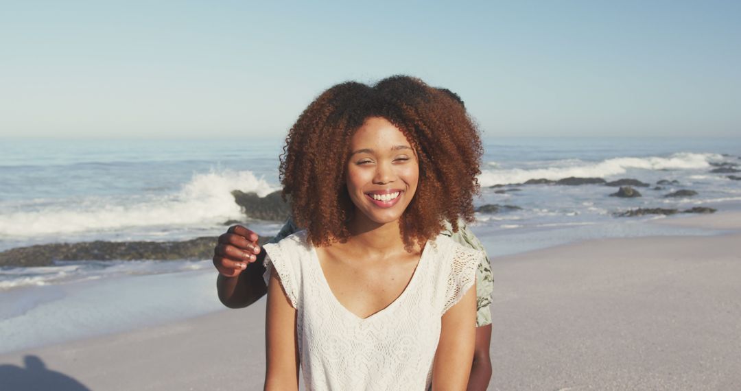 Smiling Woman at Beach with Wavy Hair and White Top - Free Images, Stock Photos and Pictures on Pikwizard.com