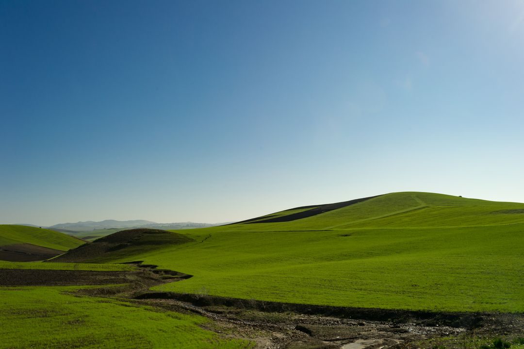 Peaceful Green Hills Under Clear Blue Sky - Free Images, Stock Photos and Pictures on Pikwizard.com