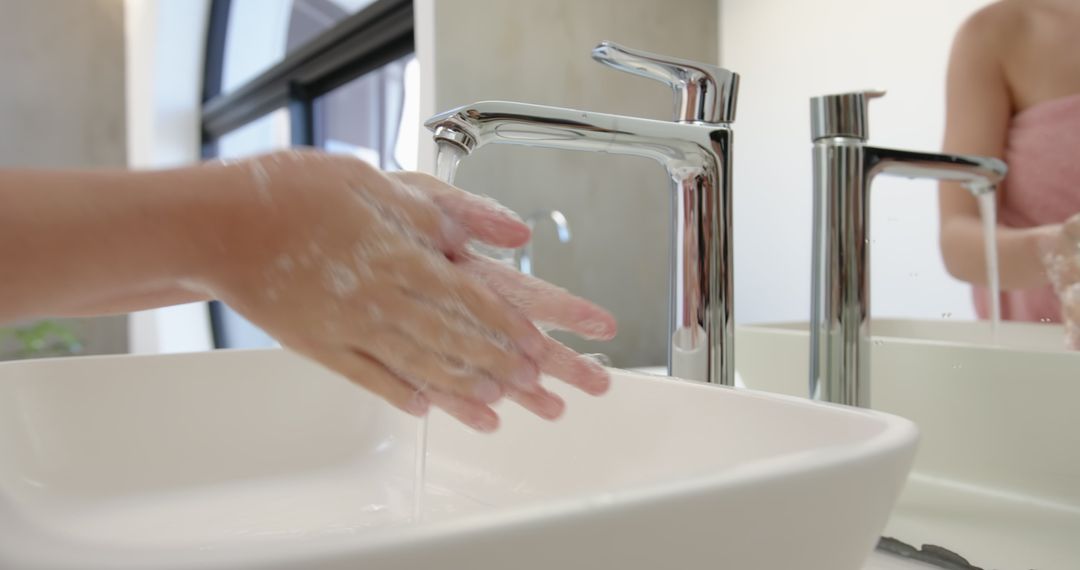 Hands Lathering Soap at Bathroom Sink for Hygiene