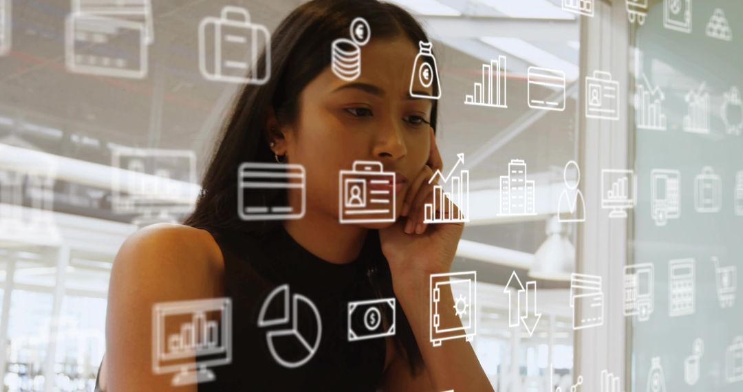 Young professional studying financial data through transparent interface in modern office