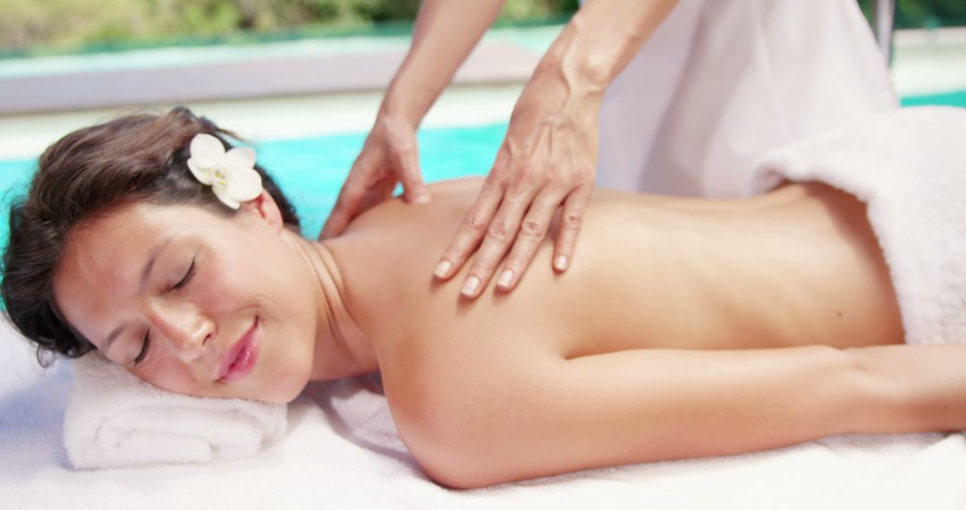 Woman Enjoying Outdoor Spa Massage at Poolside Resort - Free Images, Stock Photos and Pictures on Pikwizard.com