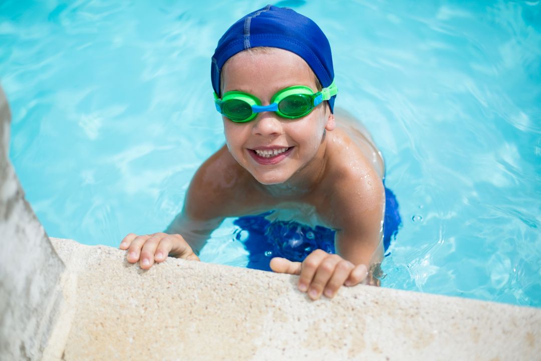 Smiling Boy in Swimming Pool with Goggles and Swim Cap - Free Images, Stock Photos and Pictures on Pikwizard.com