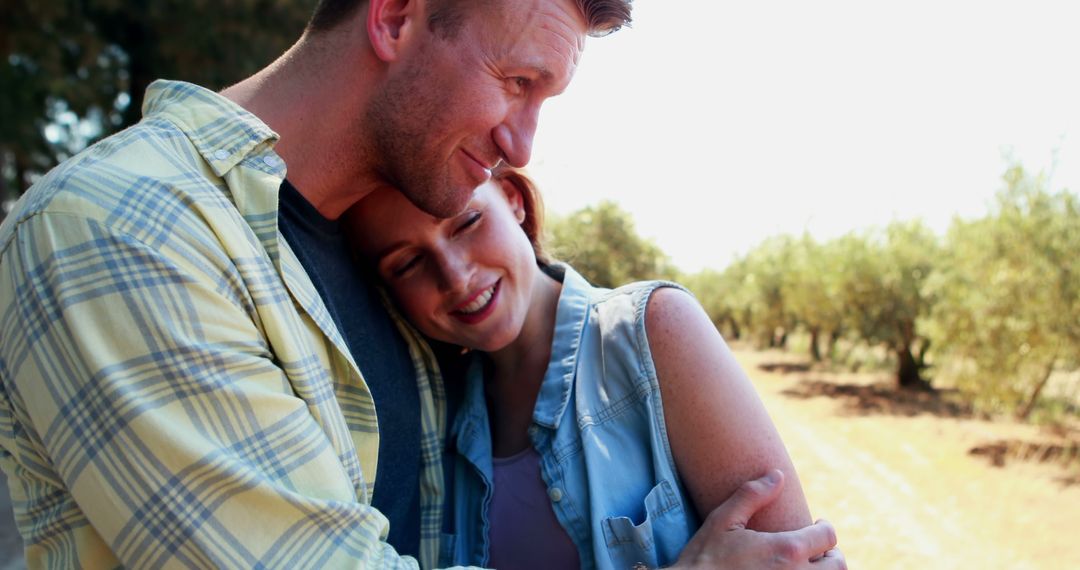 Happy Couple Embracing Outdoors in a Countryside Field - Free Images, Stock Photos and Pictures on Pikwizard.com