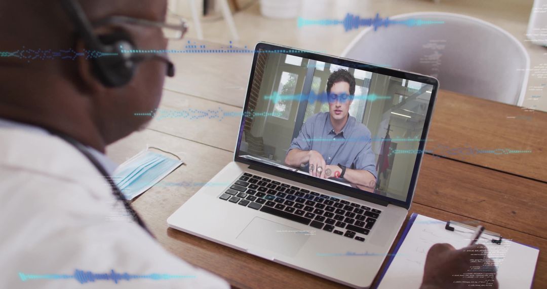 Doctor Conducting Virtual Consultation Using Laptop at Office Desk