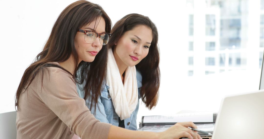 Creative Team Collaborating with Laptop in Modern Studio