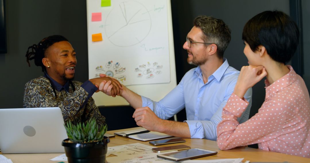 Diverse Business Team Handshaking in Modern Office