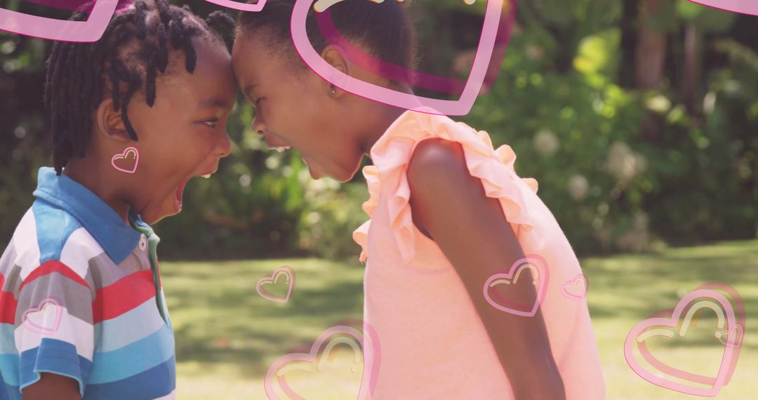 Playful Sibling Interaction with Heart Graphics in Outdoor Setting