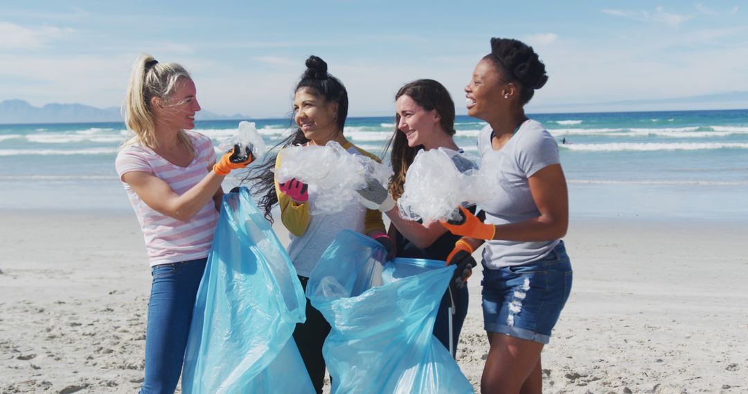 Diverse Women Collecting Beach Litter on a Sunny Day - Free Images, Stock Photos and Pictures on Pikwizard.com