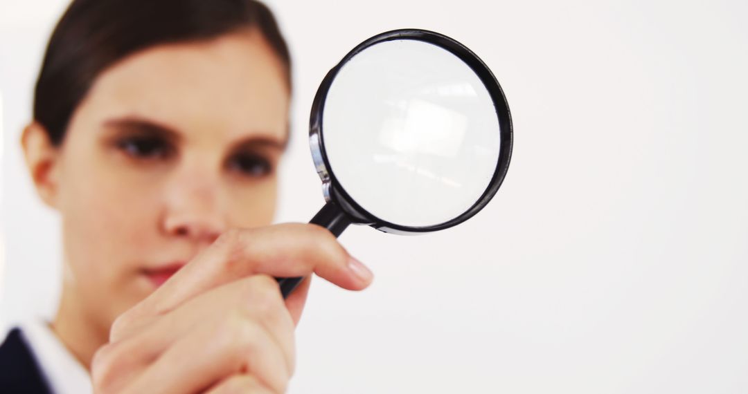 Close-up of Woman Examining Object with Magnifying Glass - Free Images, Stock Photos and Pictures on Pikwizard.com