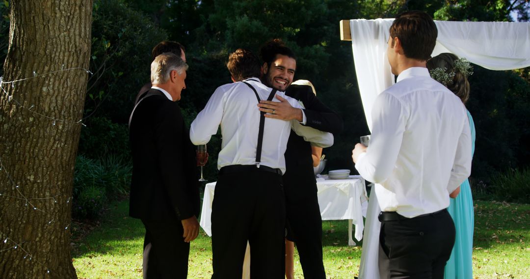 Groomsmen Hugging Each Other during Outdoor Wedding Ceremony - Free Images, Stock Photos and Pictures on Pikwizard.com