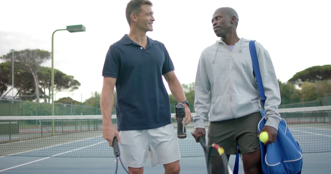 Happy Tennis Teammates Communicating Along Court - Free Images, Stock Photos and Pictures on Pikwizard.com