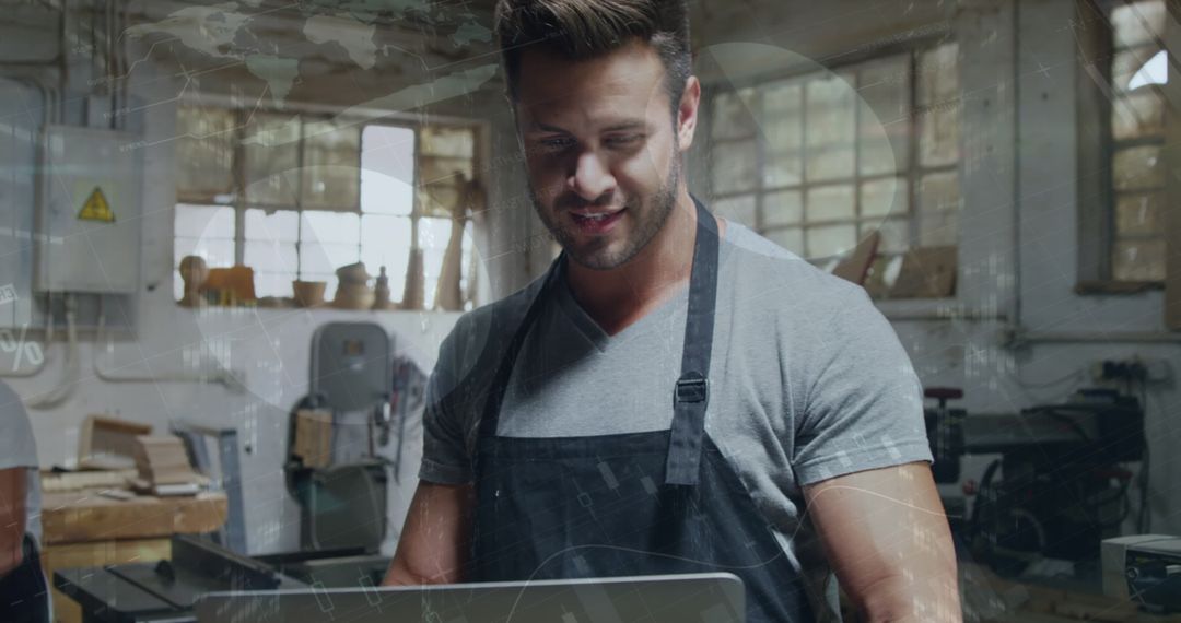 Craftspiring Artisan Using Laptop in Workshop Leveraging Technology