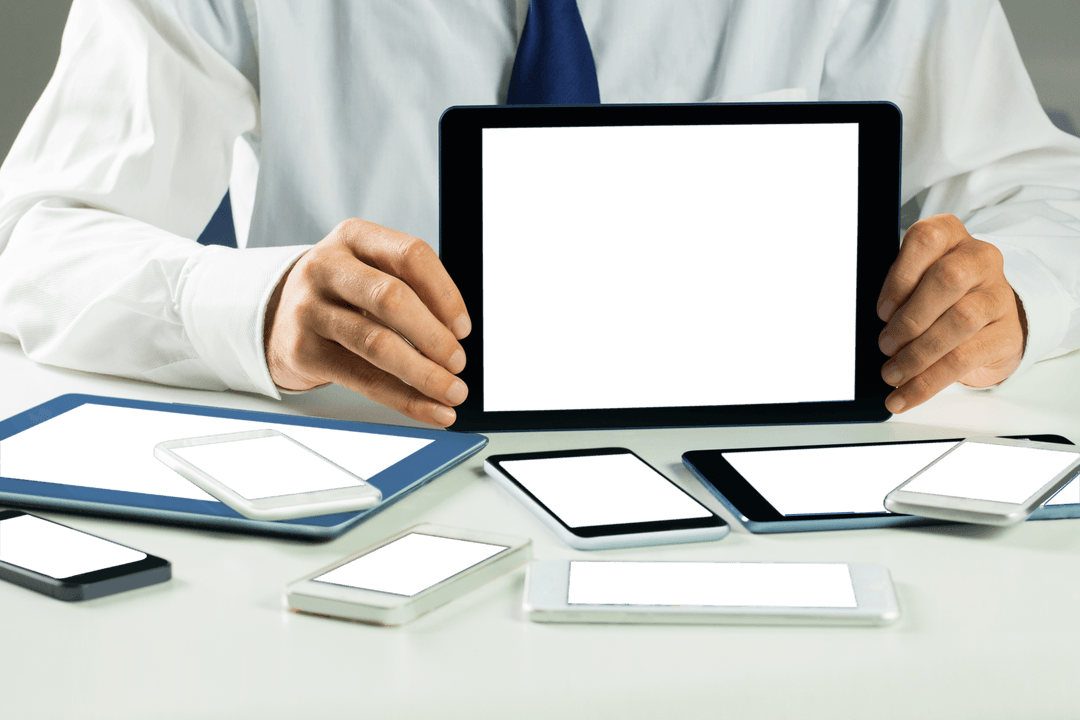 Caucasian Businessman Displaying Variety of Digital Devices on Transparent Surface