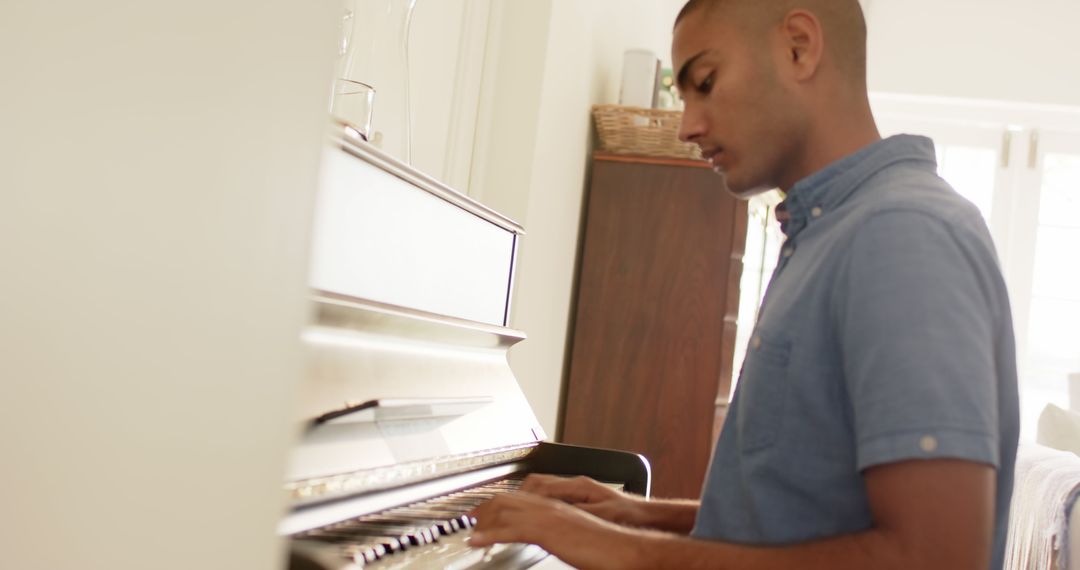 Man Playing Piano at Home in Bright Living Room - Free Images, Stock Photos and Pictures on Pikwizard.com