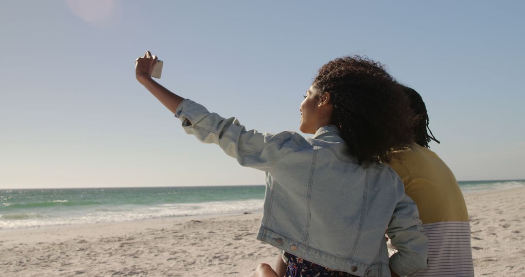 Couple Taking Selfie on Beach Against Clear Sky - Free Images, Stock Photos and Pictures on Pikwizard.com