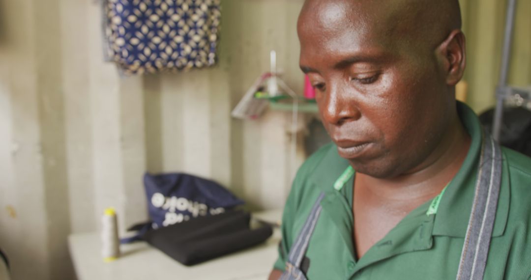African Tailor Working Diligently in Local Workshop
