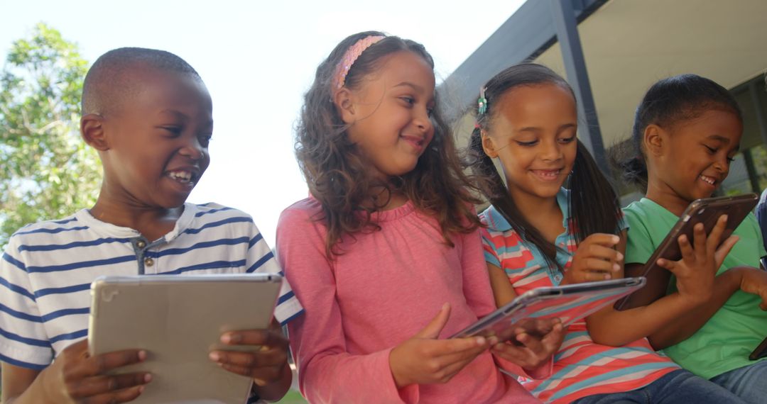 Diverse Group of Kids Sharing Tablets Outdoors Smiling
