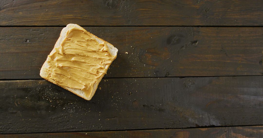 Close-Up of Toast with Creamy Peanut Butter on Rustic Tabletop