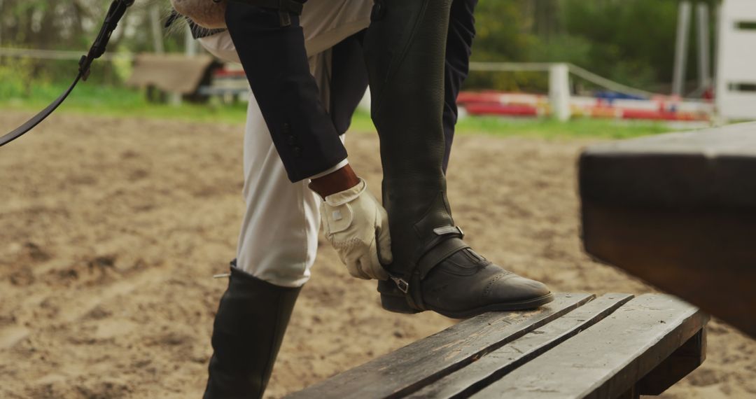 Equestrian adjusting boot before horse riding - Free Images, Stock Photos and Pictures on Pikwizard.com