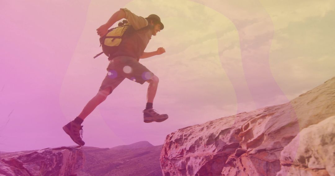 Adventurous Hiker Leaping Over Desert Rocks in Vibrant Landscape