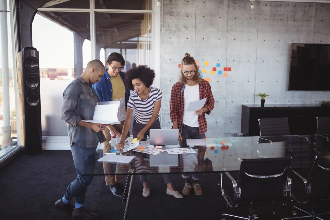 Colleagues discussing ideas in creative office - Image