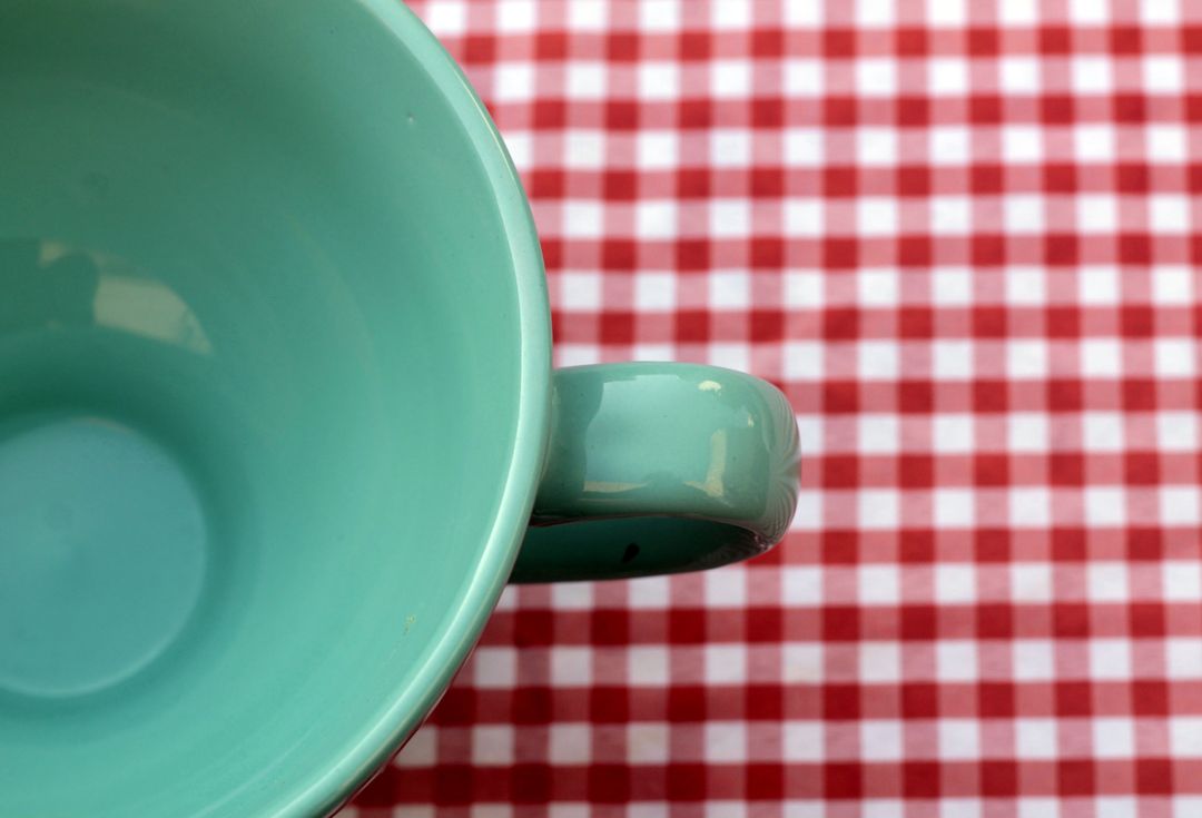 Green Ceramic Cup on Top of White and Red Checkered Print Textile - Free Images, Stock Photos and Pictures on Pikwizard.com