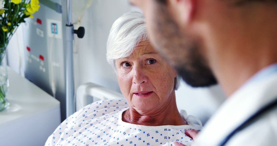 Concerned Elderly Woman Talking to Doctor in Hospital Room - Free Images, Stock Photos and Pictures on Pikwizard.com